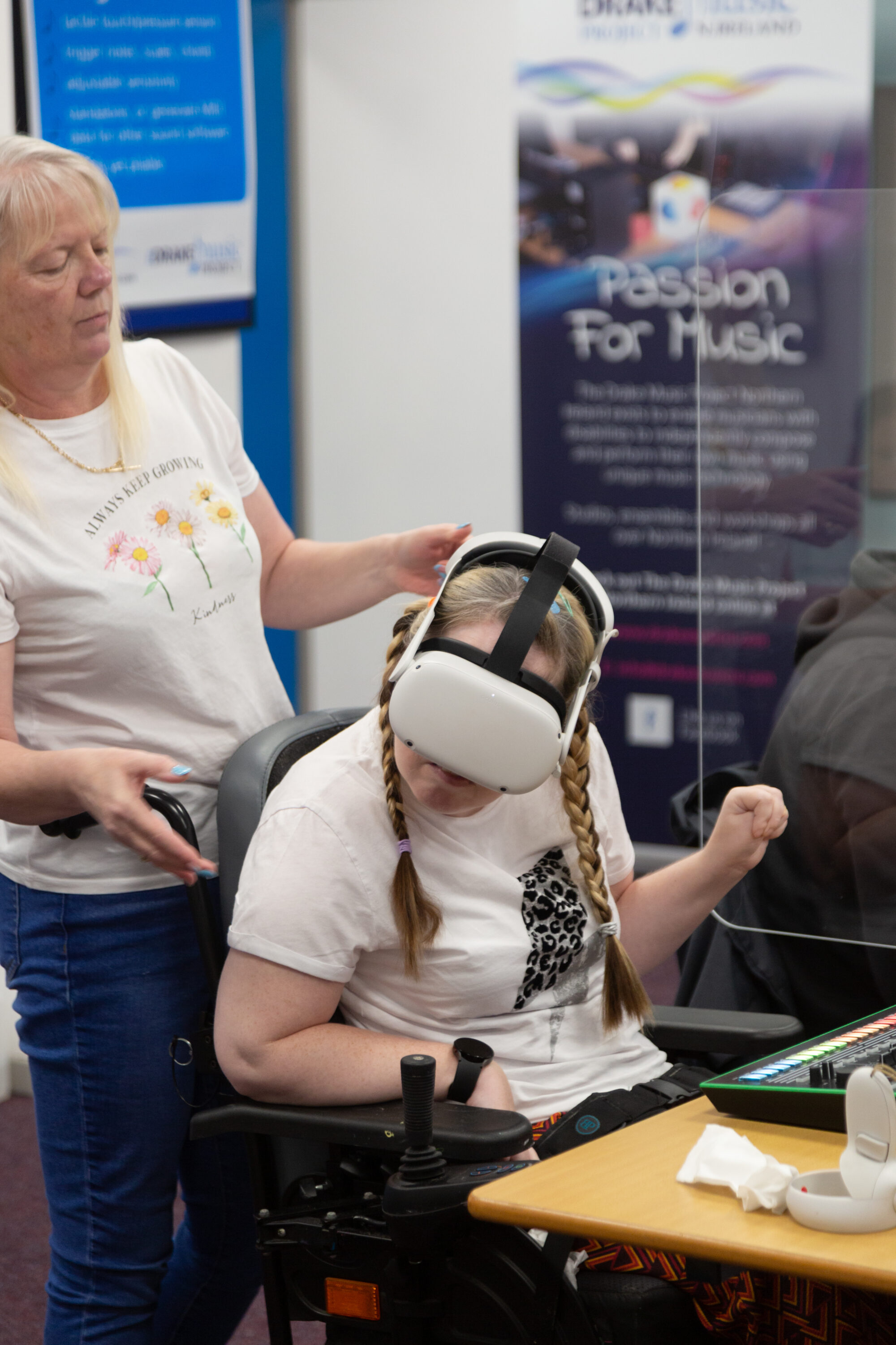 Musician Marylouise plays virtual instrument through a VR headset, accompanied by her sister and carer Michelle, during Wired Ensemble session at Drake's studio in Belfast.
